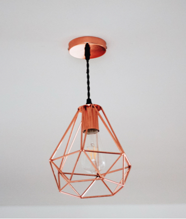 A copper geometric wire pendulum light fixture.